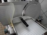 a large slicer sitting on a counter in a kitchen