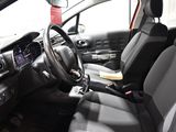 a red car with black seats and a steering wheel
