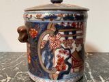 a blue and red vase sitting on a marble table