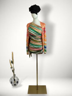 an image of a mannequin wearing a multicolored dress and hat