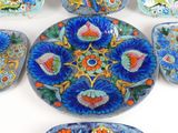 a lot of colorful plates and bowls on the table