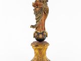 an image of a statue of a woman holding a child on top of a globe