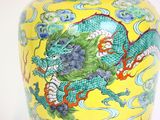 a yellow vase with a dragon painted on it