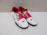 pair of red and white nike shoes on a white surface
