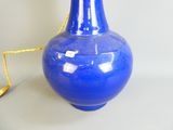 a blue vase with a yellow cord attached to it