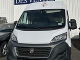 a white van that is parked in front of a building
