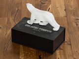 a white polar bear figurine sitting on a black box