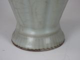 a white vase that is sitting on a table