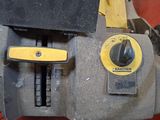 a close up of a machine with a yellow button
