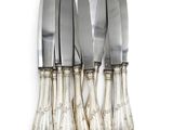 a set of five silverplated knives with a silver handle
