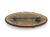 a metal pin with a pin on it on a white surface