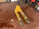 a forklift in a garage with a fork on it