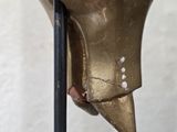 a bronze statue of a man ' s head on a stand