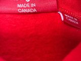 the label on a red shirt reads large made in canada