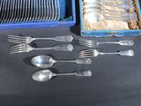 a lot of silverware in a blue box on a table