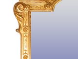 a mirror with a gold frame on a white background