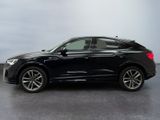 a black audi qx parked in a parking lot