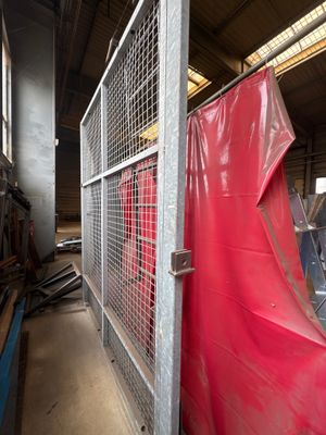 a red tarp covering a metal gate in a building