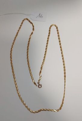 a close up of a gold chain on a white surface