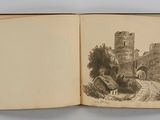 an open book with a drawing of a castle on it