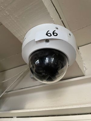 a surveillance camera mounted on the ceiling of a building