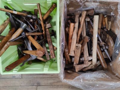 two bins filled with different types of tools on the floor
