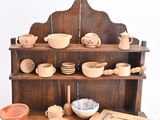 a small wooden table with bowls and plates on it