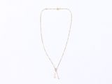 a necklace with a gold chain and a white bead on a white background