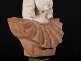 a white marble bust of a woman with long hair on a pedestal