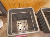 two bins that are sitting next to each other on the floor