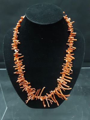 a close up of a necklace on a mannequin display
