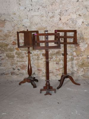 a wooden stand with a mirror on it in front of a brick wall