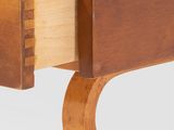 a close up of a wooden desk with a drawer underneath it