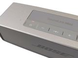 a silver speaker that is sitting on top of a table
