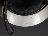 a close up of a motorcycle helmet with a red dot on it