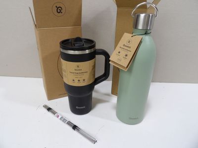 a coffee cup and a water bottle next to a box