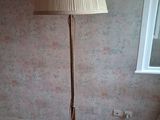 a lamp that is on a wooden floor in a room