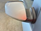 a side view mirror of a car with a red light on it