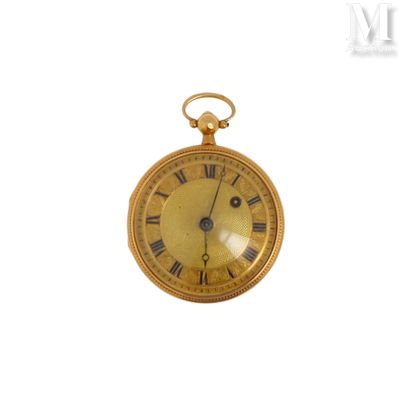 une montre de poche en or avec des chiffres romains sur le cadran