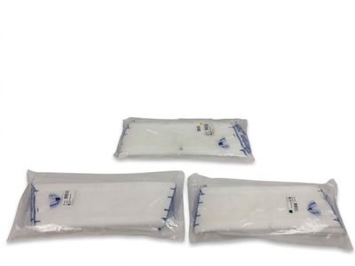 trois sacs en plastique blanc sont posés sur une surface blanche