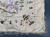 a piece of cloth with a picture of people and animals on it