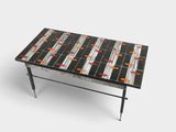 a black and white table with orange and white tiles on it