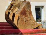 a large piece of wood sitting on top of a red fire hydrant