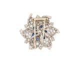 an image of a diamond and sapphire broochle on a white background