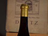 a bottle of wine sitting on a table next to a book