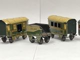 several toy trains are lined up in a row on a white surface