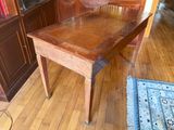 a wooden table that is sitting in the middle of a room