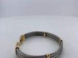 a cable bracelet with two gold clasps on a white surface