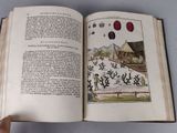 someone is holding a book open to a page with a drawing on it