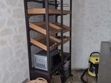 a room with a shelf and a basket on the floor